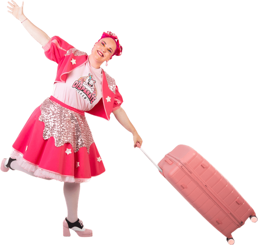 Cuca walking with her pink suitcase and one arm in the air