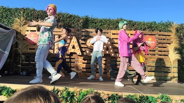 Boys and girls dancing against each other on stage, each team on one side